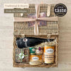 Tariette Barnabé Dordogne food hamper open with duck confit, cassoulet, rillettes, terrine, red wine and caramelised almonds.