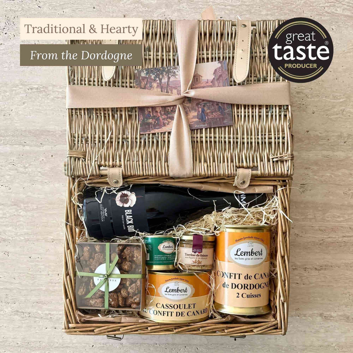 Tariette Barnabé Dordogne food hamper open with duck confit, cassoulet, rillettes, terrine, red wine and caramelised almonds.