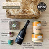 Barnabé hamper contents laid out: duck confit, duck cassoulet, duck rillettes, pheasant terrine, red wine and caramelised almonds.
