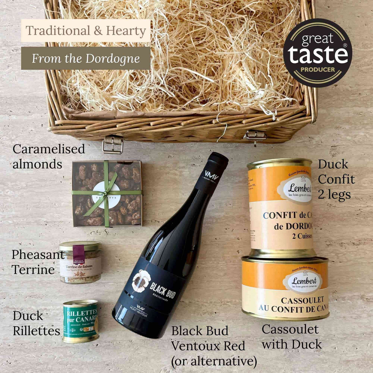 Barnabé hamper contents laid out: duck confit, duck cassoulet, duck rillettes, pheasant terrine, red wine and caramelised almonds.