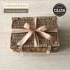Tariette Barnabé Dordogne gift hamper in a closed wicker basket tied with a peach ribbon.
