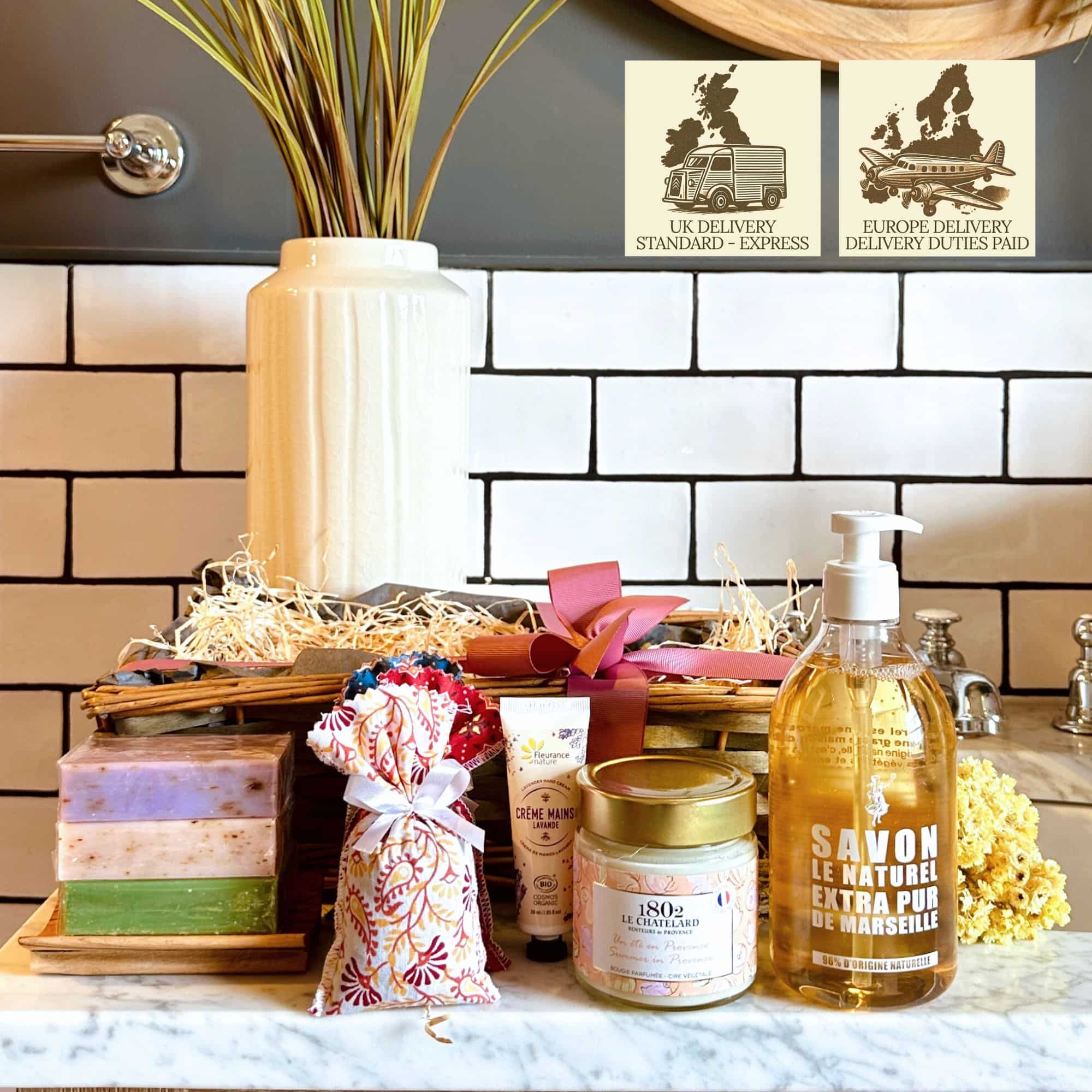Box Les Bains captures the essence of Provence with artisan soaps, a scented candle, liquid hand soap, an olive wood dish, and a bunch of lavender.