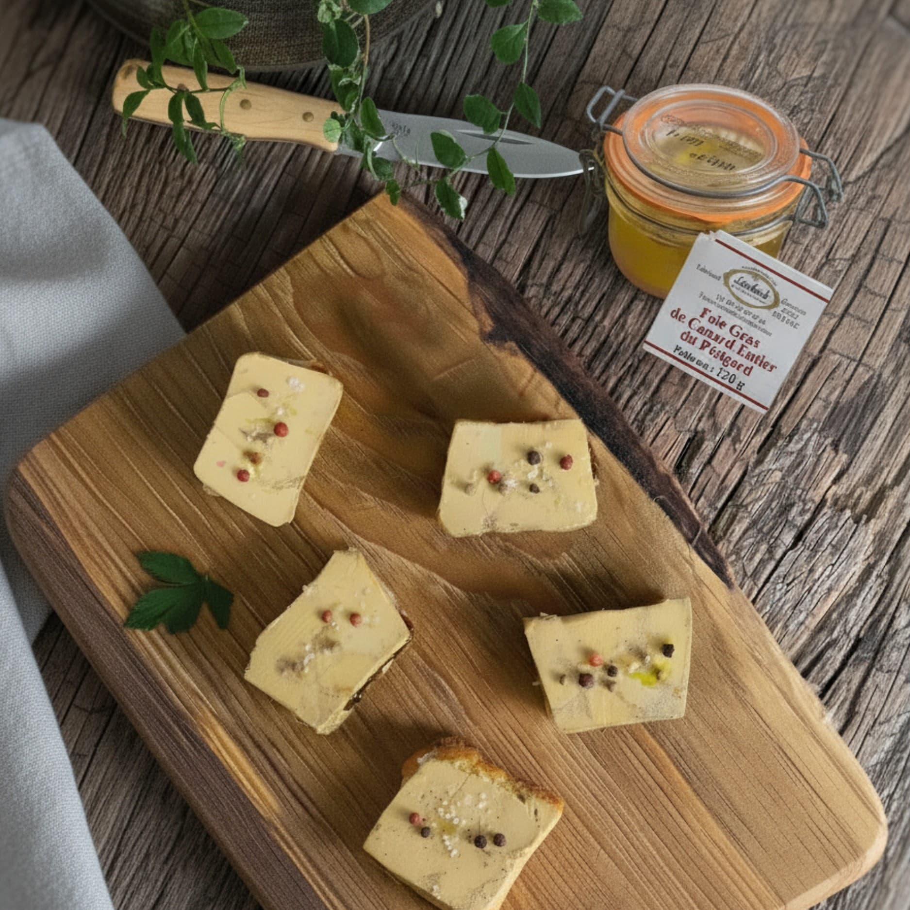 toasts of French foie gras entier on a rustic board