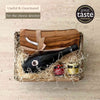 Tariette Fromage gift basket with an olive wood cheese board, Laguiole cheese knife, red wine and two chutneys.