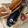 Close-up of the Fromage gift basket showing the olive wood board, cheese knife, red wine and fig chutney.