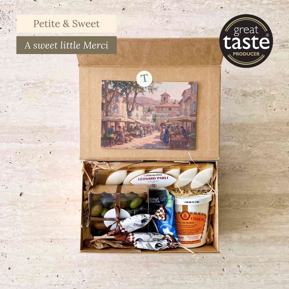 Tariette Gourmand French gift box open with calissons, chocolate almonds, caramel lollies, sweets and Provence honey.