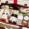 Indulge in Hamper Manon — a stylish French hamper with chocolate almonds, hazelnut spread, blackcurrant jam, and a fine sparkling wine.