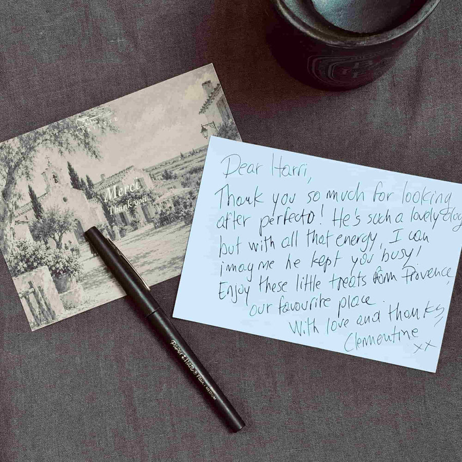 Tariette Merci thank you card with vintage Provençal village illustration, handwritten thank you message and black pen.
