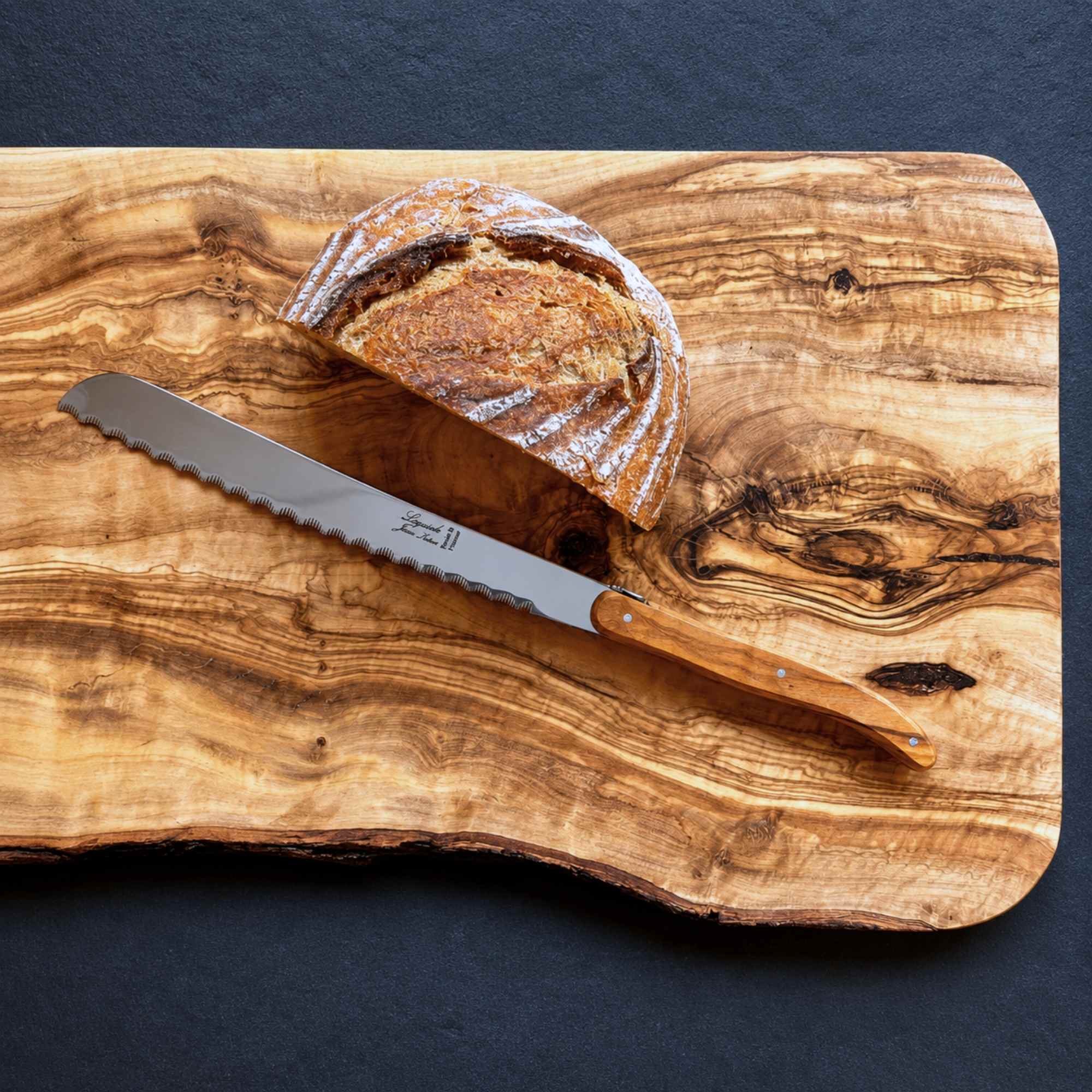 Laguiole bread knife with sharp serrated blade and olive wood handle