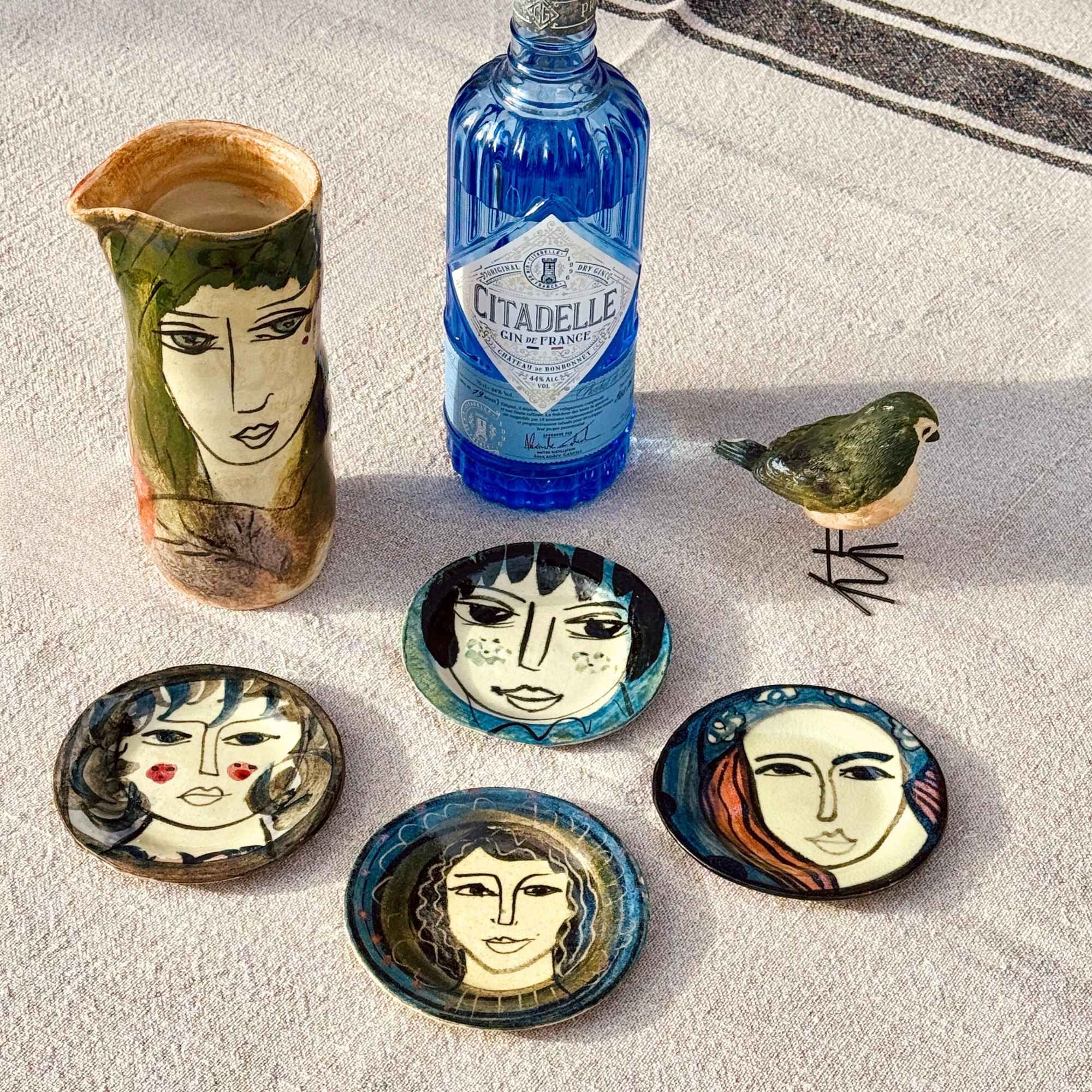 Les Silencieuses, Hand painted plates with ladies’ faces by E.V.