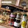 Close-up of the Lio vegan hamper with aubergine spread, black garlic hummus, artichoke spread, jam, olive oil and almonds.