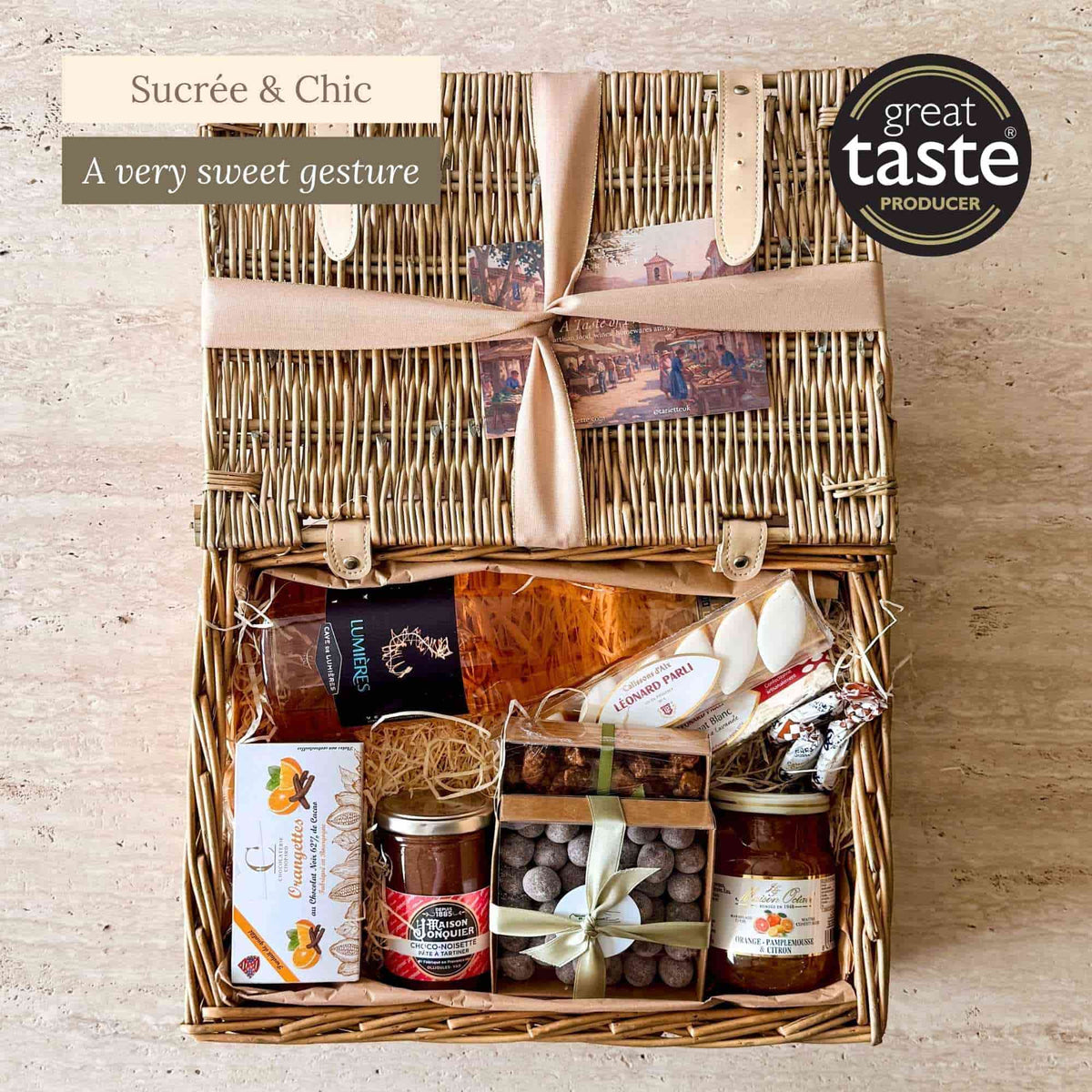 Tariette Manon sweet French hamper open with rosé wine, calissons, nougat, chocolate orangettes, almonds, preserves and caramel lollies.