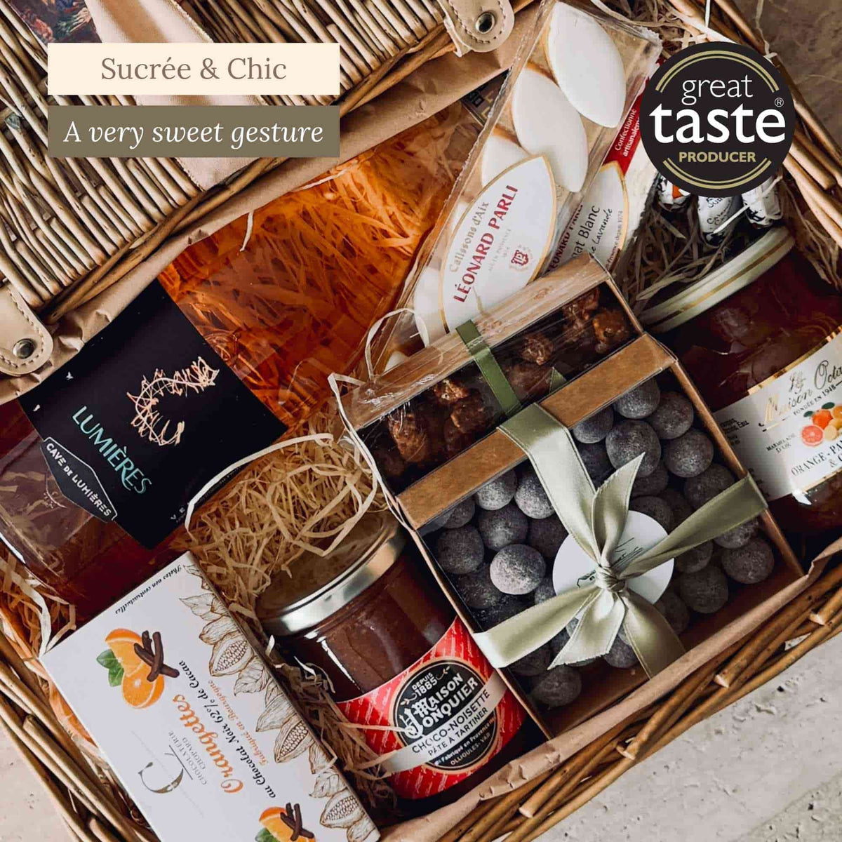 Close-up of the Manon sweet hamper with chocolate almonds, calissons, rosé wine, chocolate spread and citrus jam.
