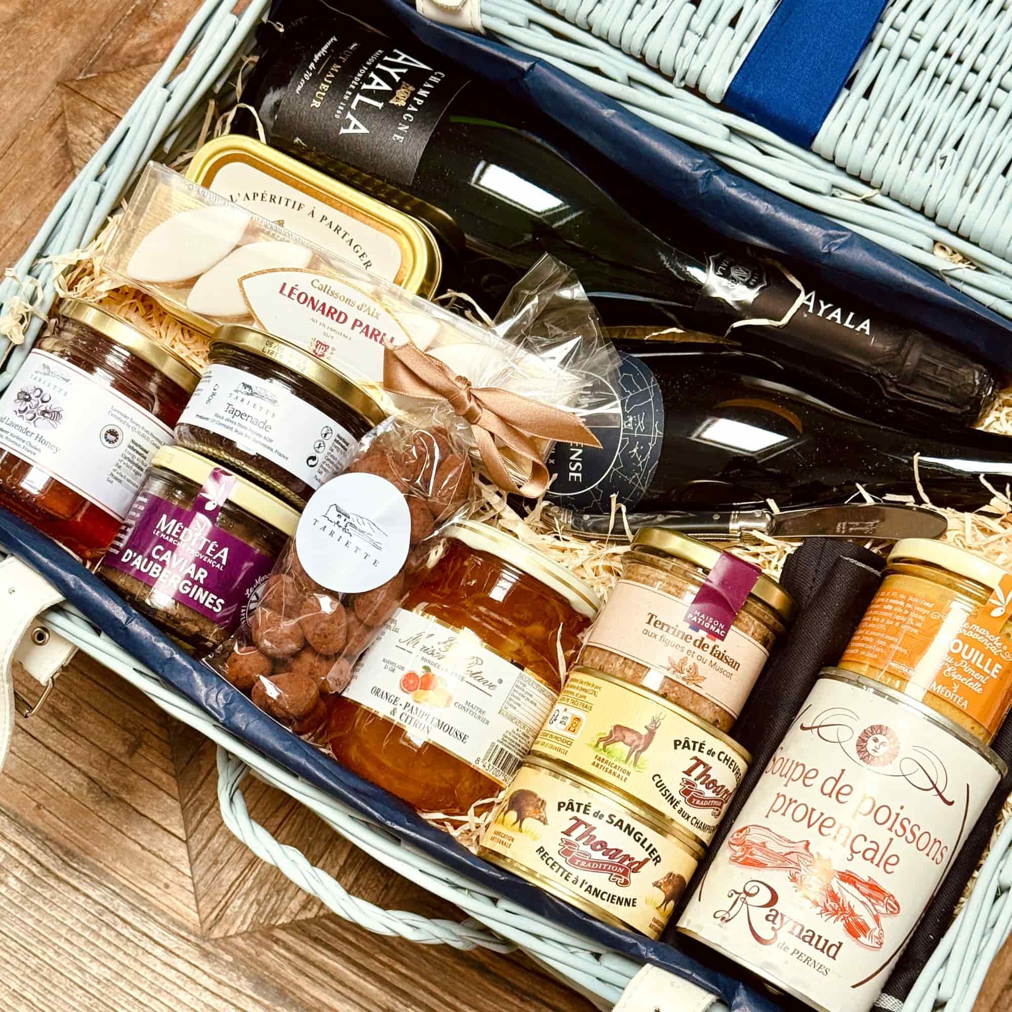 A generous gourmet hamper from France — Saturnin includes savoury delicacies, elegant wines, and sweet treats perfect for family celebrations.