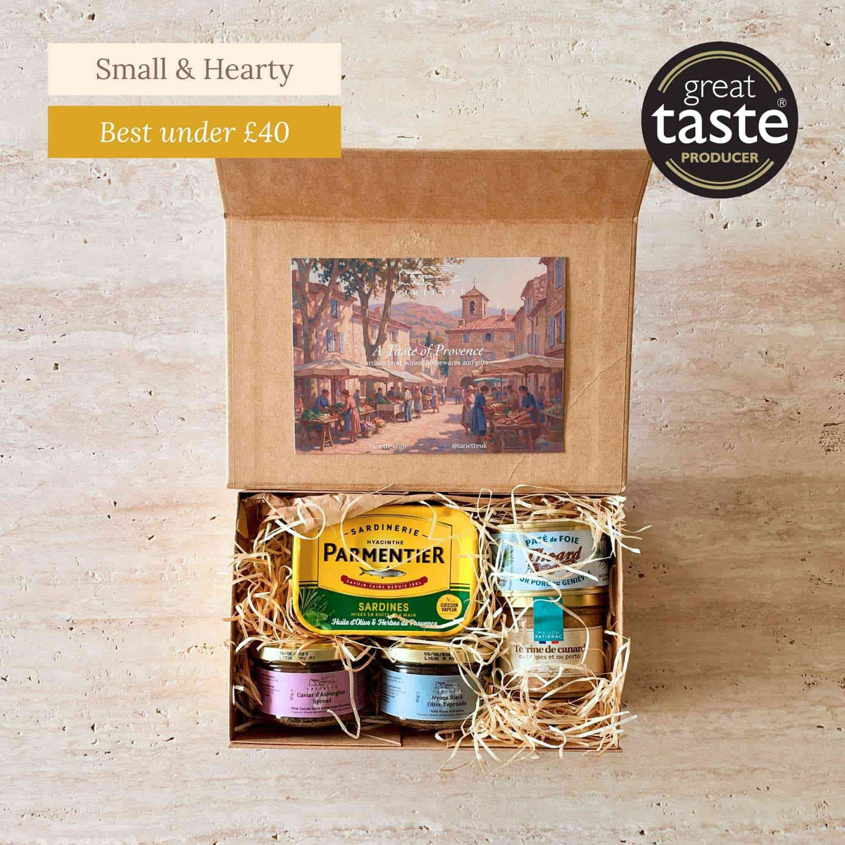Tariette Terroir French food gift box open with sardines, black olive tapenade, aubergine spread, pâté and duck terrine.