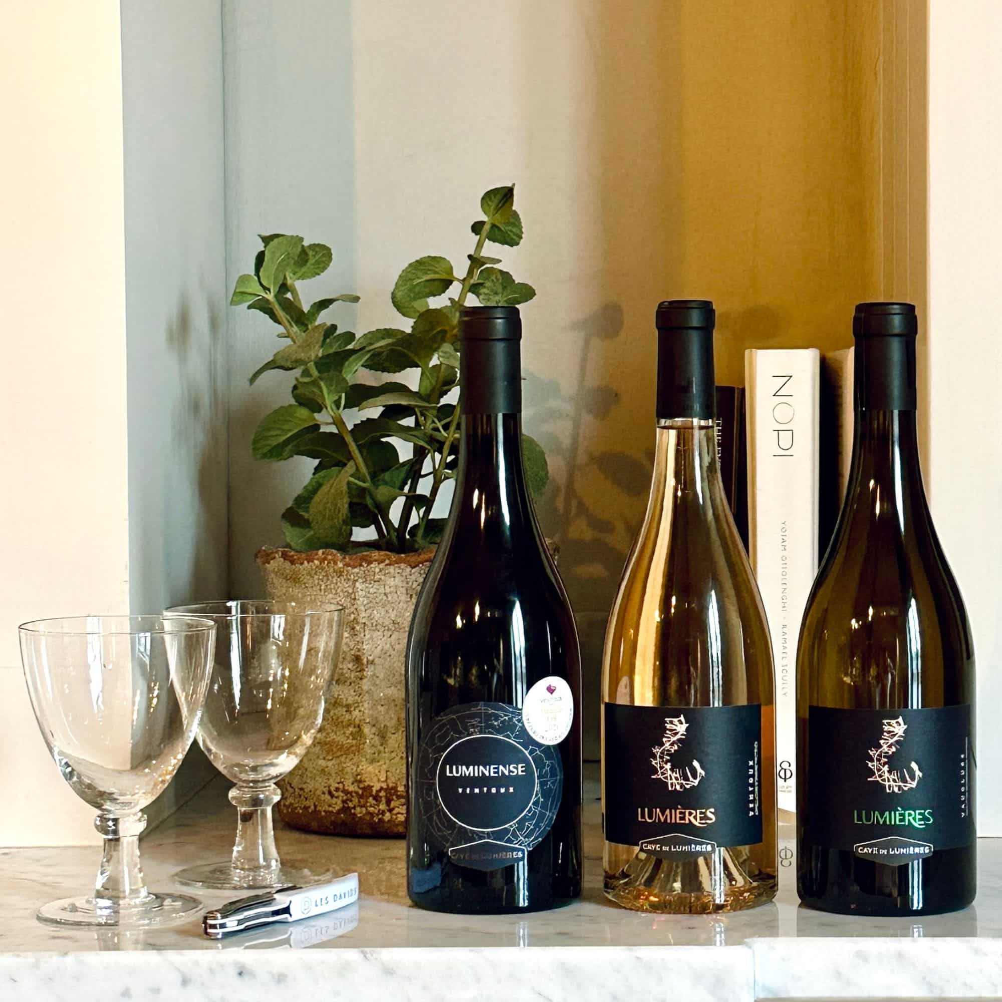 A trio of Ventoux wines from Cave de Lumières — red, rosé, and white — presented in a charming wicker basket with a beautiful bow.