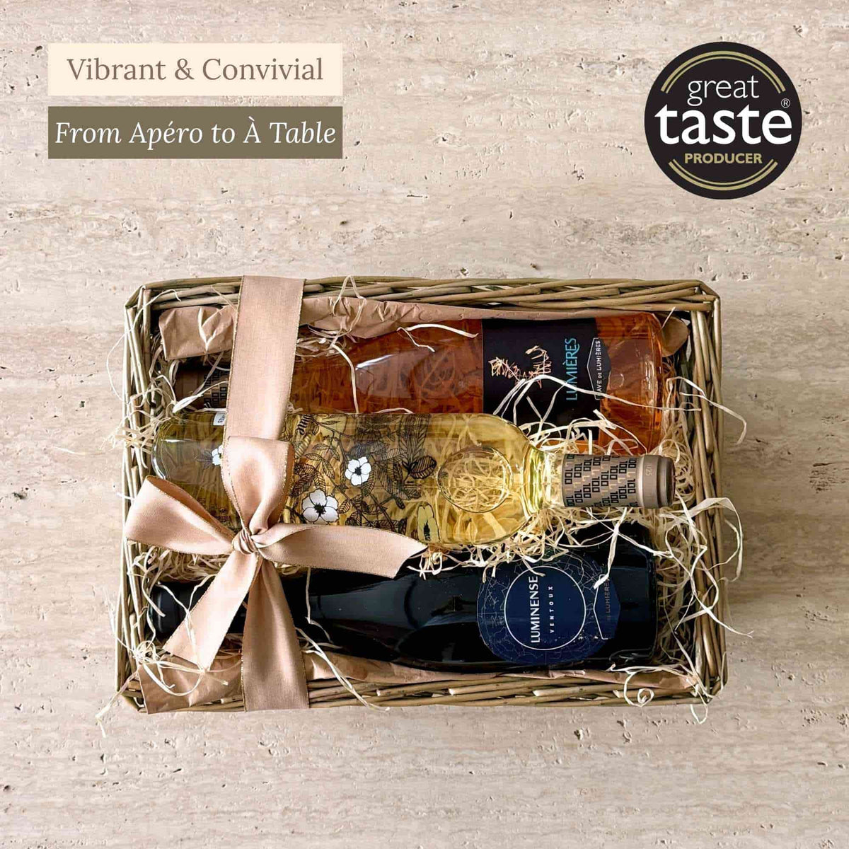 Tariette Wine Trio gift basket with red, white and rosé Ventoux wines nestled in wood wool and tied with ribbon.