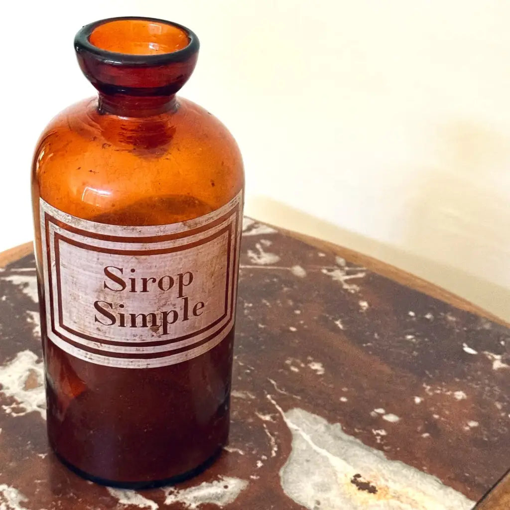 Beautiful amber glass pharmacy jar with an enamel-painted label reading Sirop Simple, dating from the late 19th to early 20th century.
