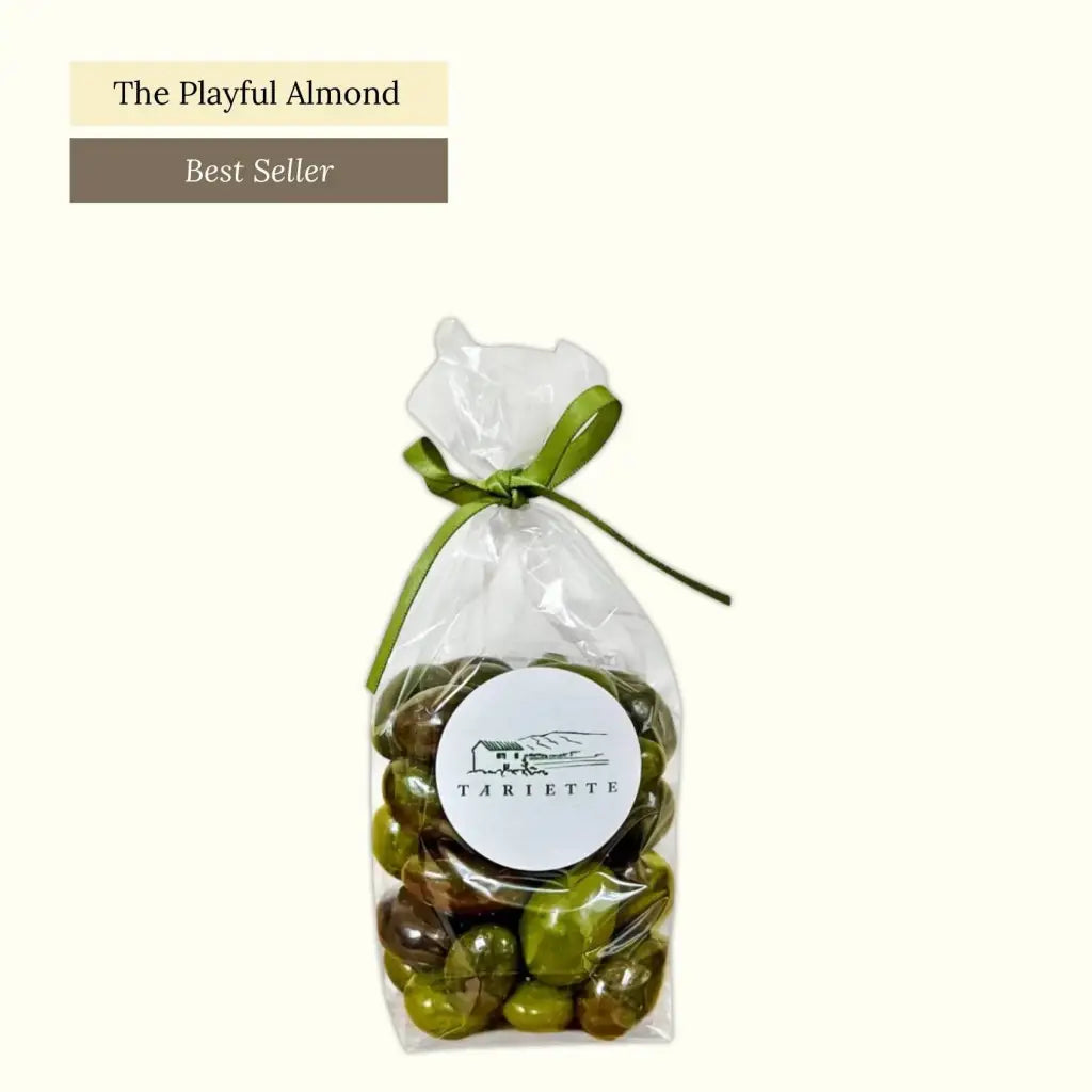 Roasted almonds, covered in dark and white chocolate, finished with green and black glazes&nbsp;to mimic olives.
