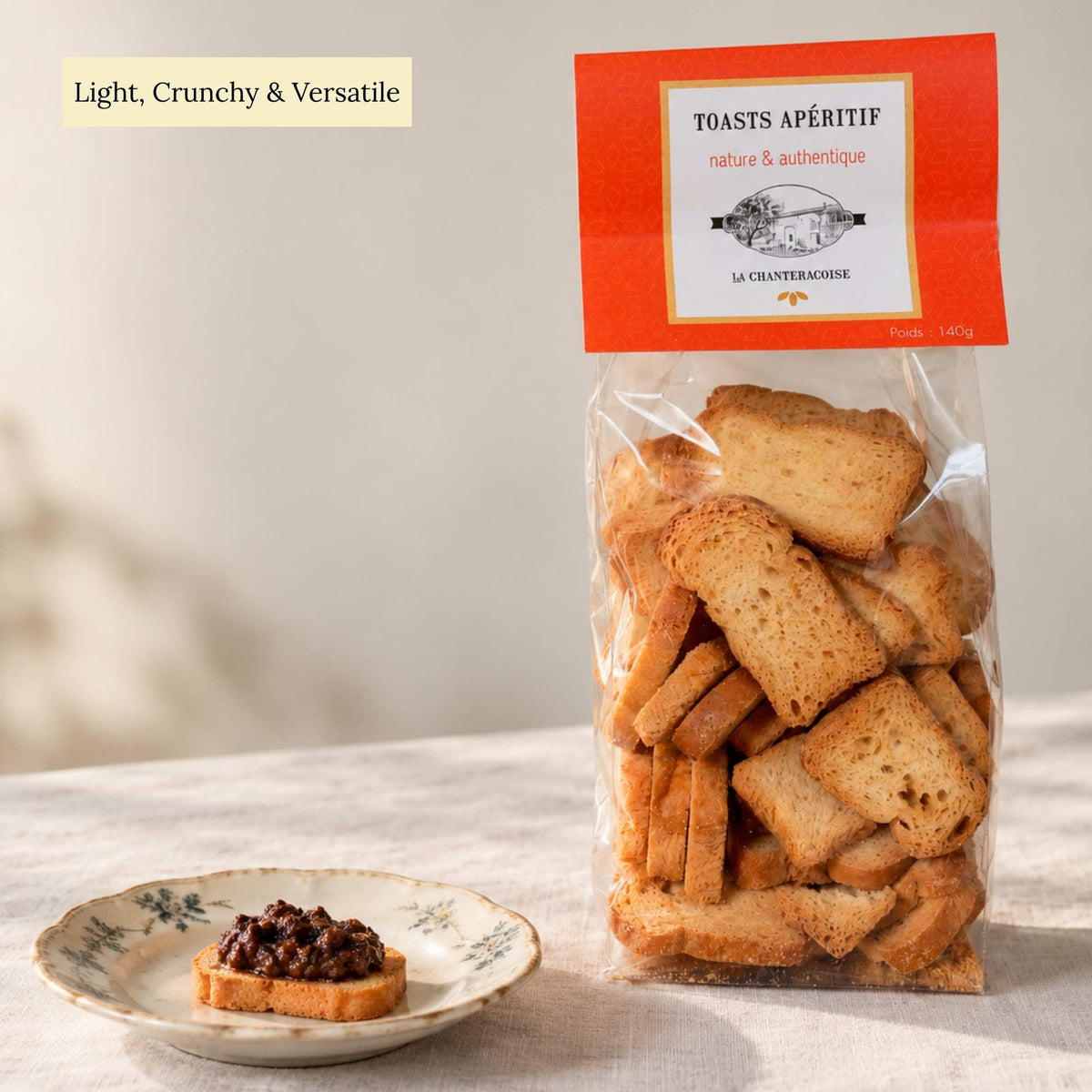 La Chanteracoise traditional French apéritif toasts 140g, with a crunchy toast topped with black olive tapenade on an antique plate.