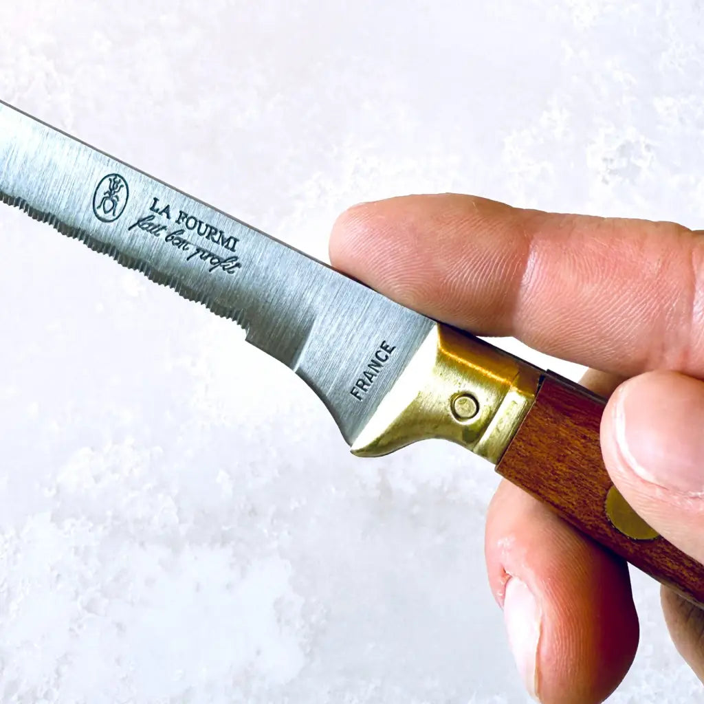 Kitchen knife with serrated blade