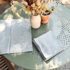 Vintage French damask cotton napkins, reimagined in a soft almond grey hue and oven with a delicate floral motif.