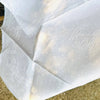 French damask cotton napkins, woven with a dotted pattern and finished with flowing embroidered initials HM. 