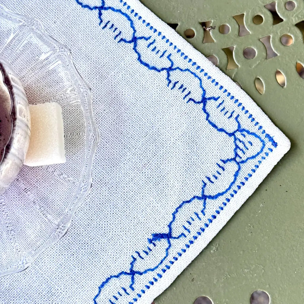 Set of 6 small vintage French cotton placemats with delicate blue embroidery, dating from the 1960s-80s. Their crisp white cotton and hand-finished blue embroidered border bring a timeless Provençal charm to the table.