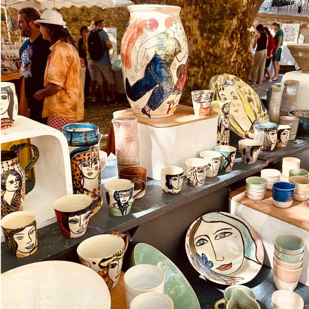 Small plate with painted ladies faces by Elisabeth V. –