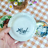 Small plate with painted ladies faces by Elisabeth V. –