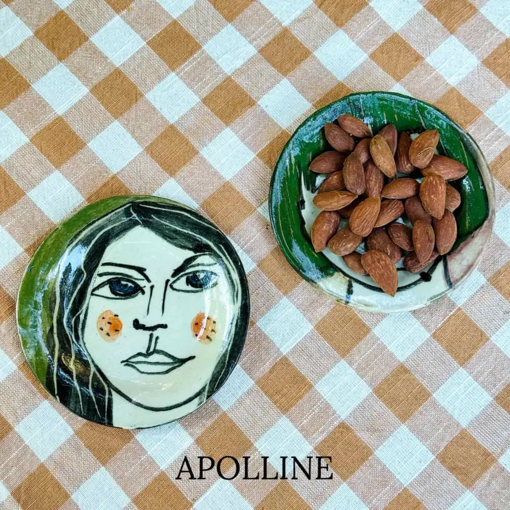 Small plate with painted ladies faces by Elisabeth V. –
