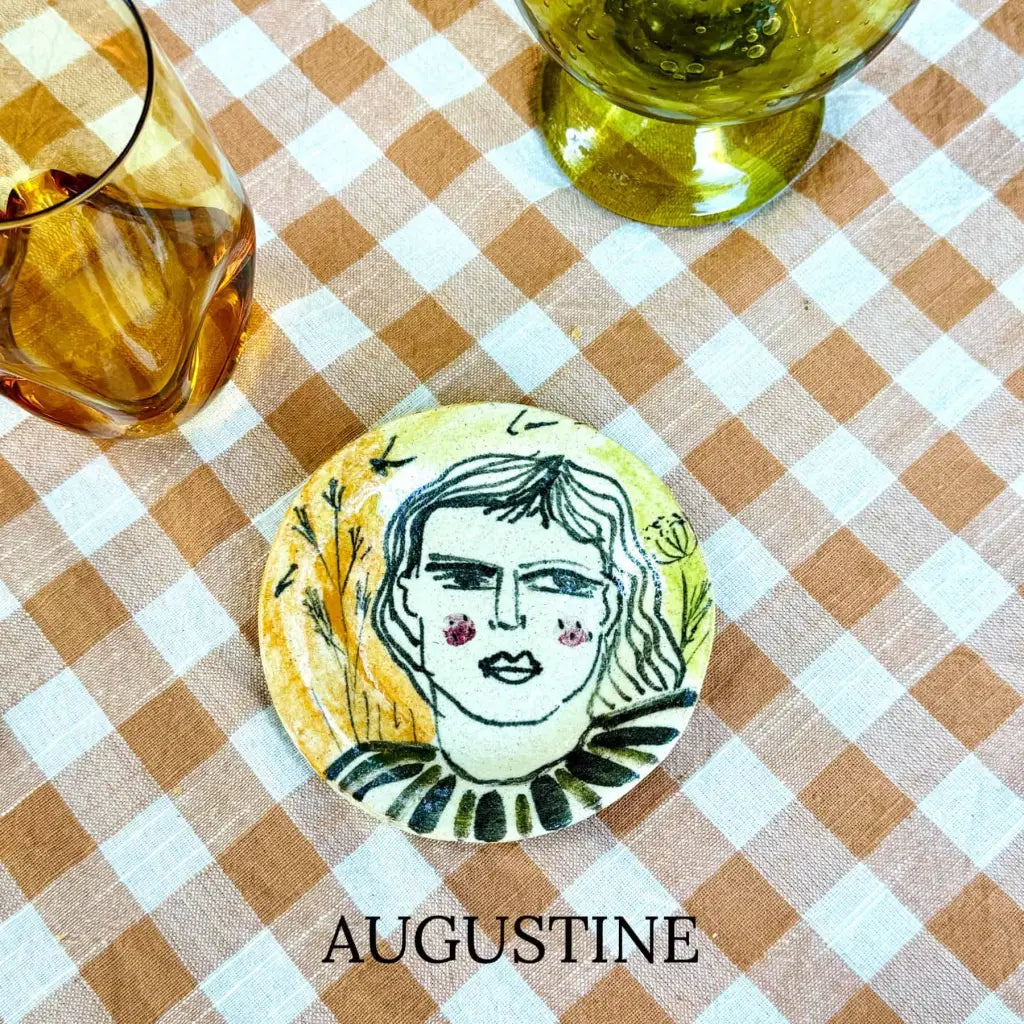 Small plate with painted ladies faces by Elisabeth V. –