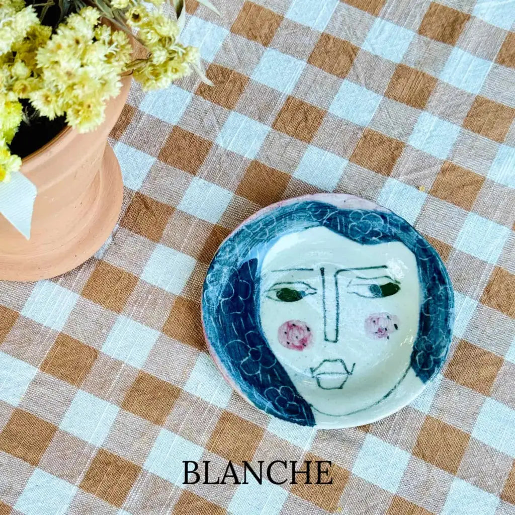 Small plate with painted ladies faces by Elisabeth V. –
