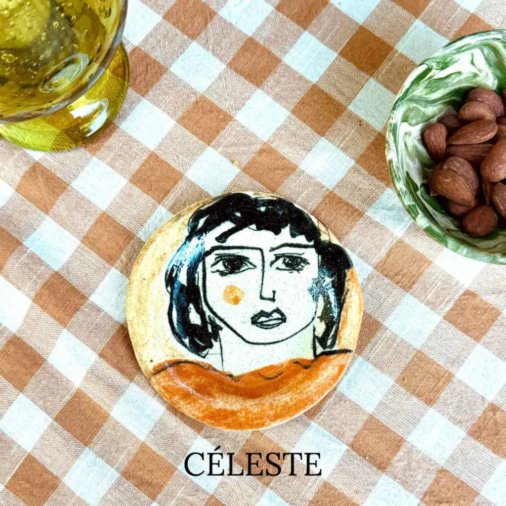 Small plate with painted ladies faces by Elisabeth V. –