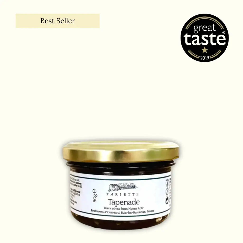 Jar of tapenade with a gold lid on a white background, featuring the 'Great Taste' award logo.