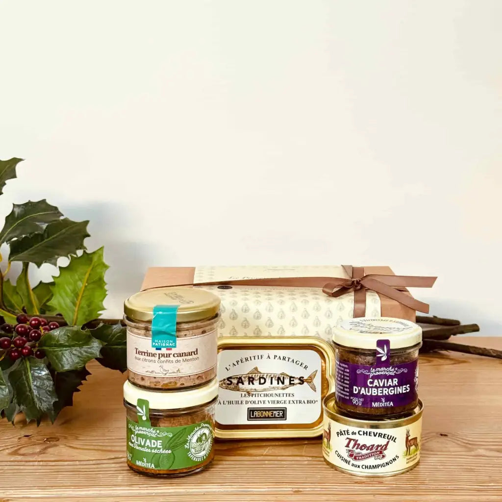 Gourmet savoury gift from Provence including olive tapenade, aubergine spread, venison pâté, duck terrine and sardines in olive oil, presented in a gift box.