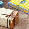 Savoury Provençal gift with olive tapenade, aubergine spread, venison pâté, duck terrine and sardines in olive oil, presented in a ribbon-wrapped box.