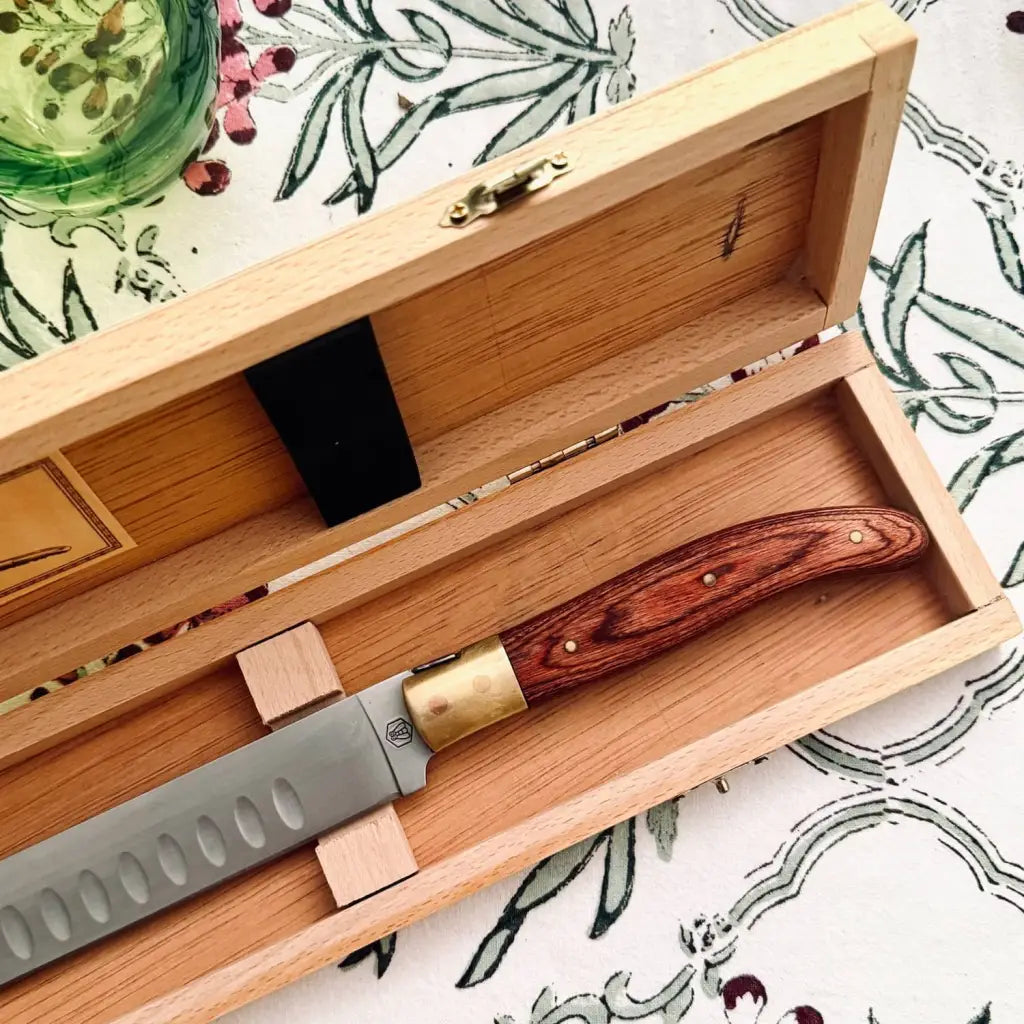 Vintage Laguiole carving knife. The blade is finished with a series of Granton edge scallops, designed to reduce friction, prevent food from sticking, and ensure smooth, precise carving.